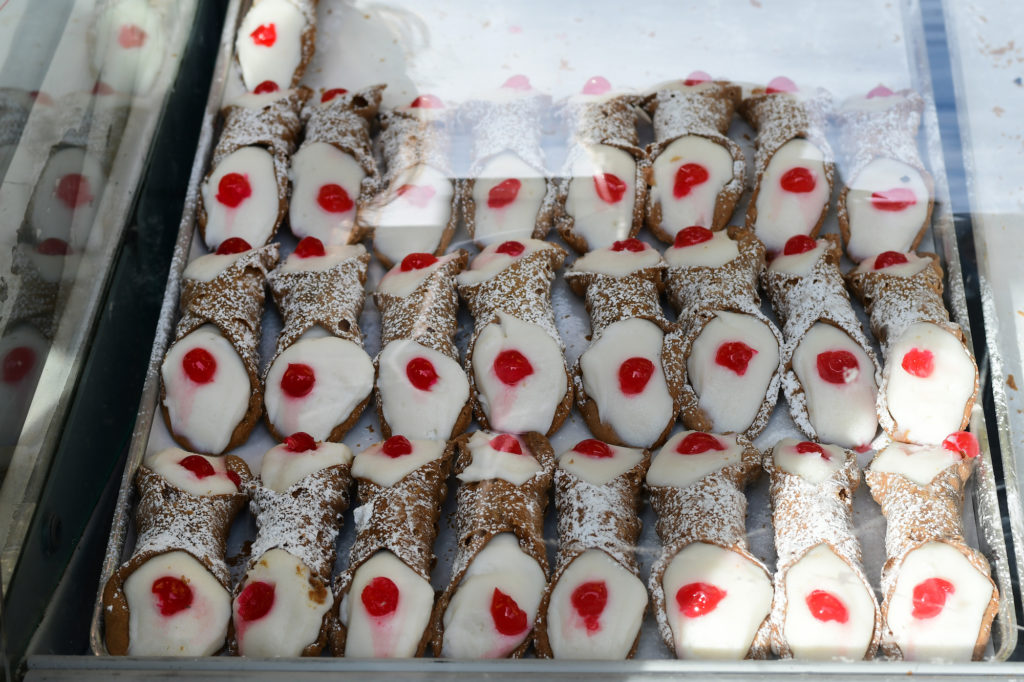 typical Italian sweets cannoli and truffles on the market in Italy. Sicilian cannoli with ricotta